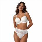 Woman wearing a white lace lingerie set on a white background