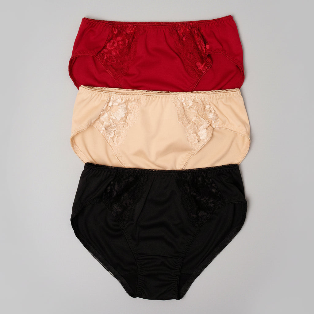 Three pairs of women's high-waisted briefs stacked vertically on a beige burlap background. The top pair is red with floral lace detailing, the middle is beige with lace detailing, and the bottom is black with lace detailing.