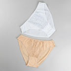 Beige and white lace-trimmed underwear on a brown background